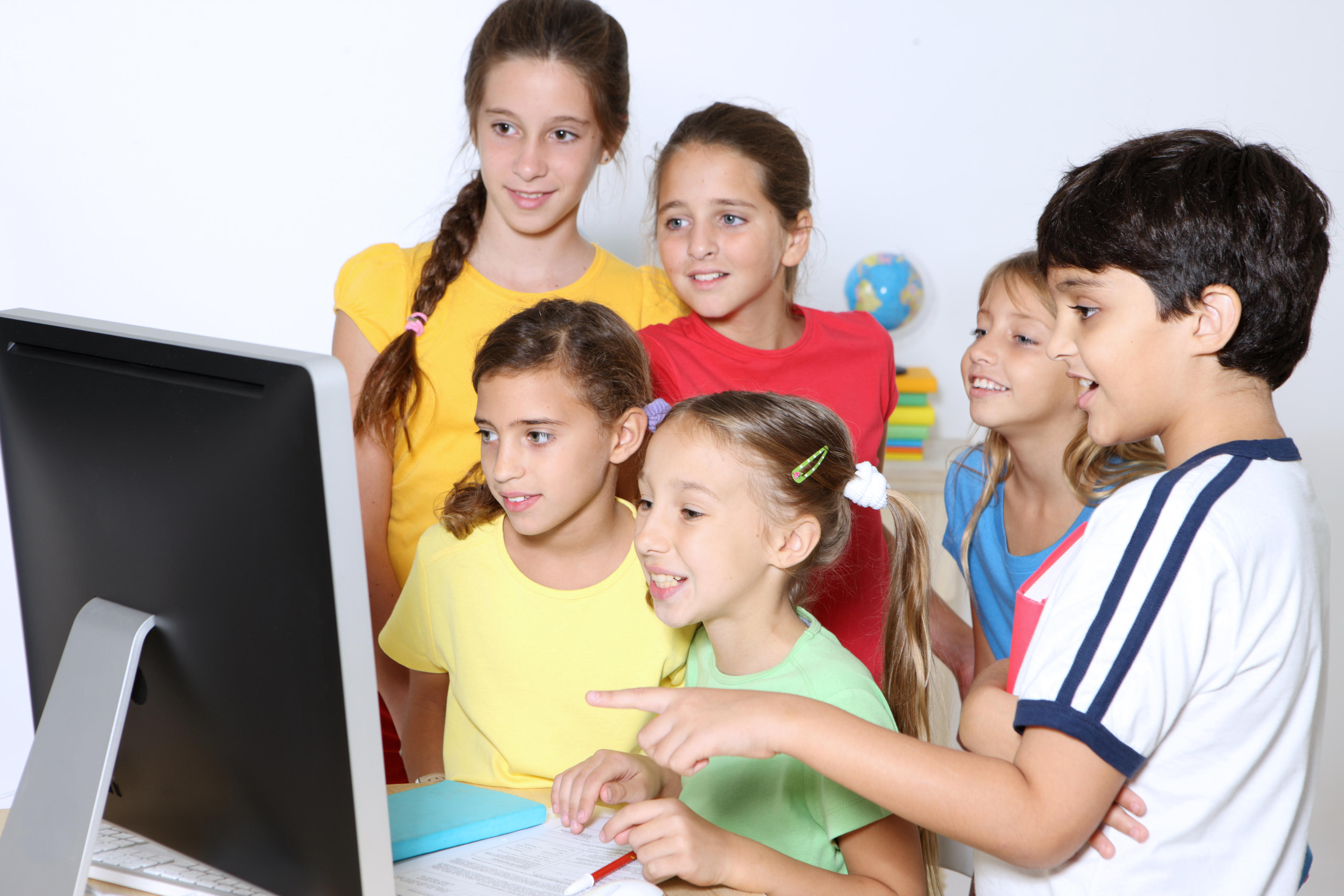 Group of children in front of a computer