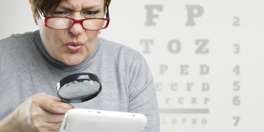 Woman reading with a magnifying glass